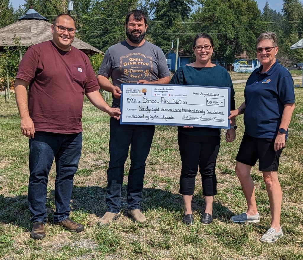 NTCF Board Chair, Louise Lodge presents a "cheque" to (l-r) Andre Taniguti, Chief George Lampreau and Rhonda Kershaw for Simpcw First Nation.